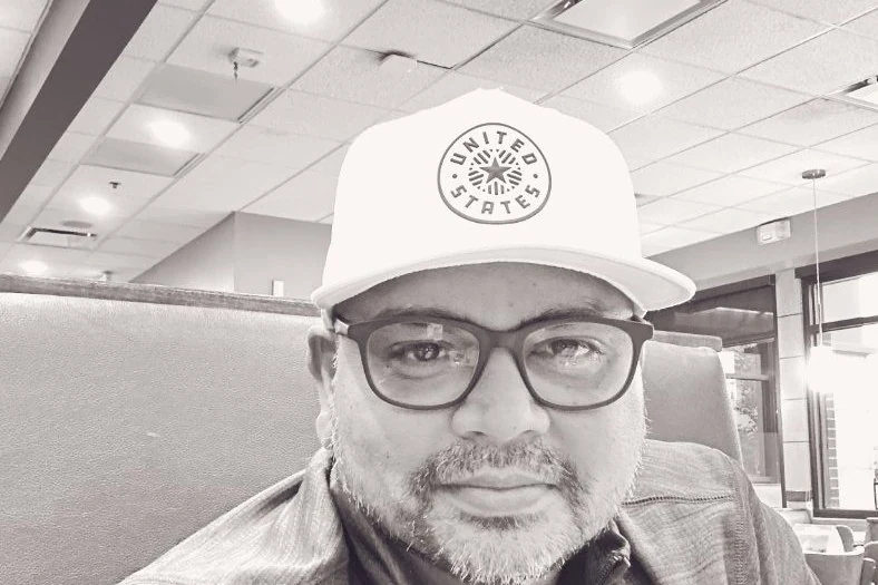 Satya Sivunigunta, operator and author of satya.me, in a cap and glasses