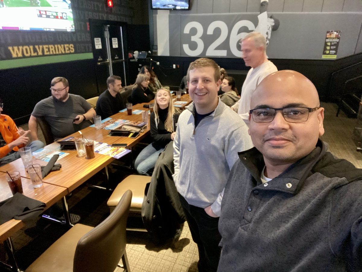 Cross-functional team collaborating around a table, trading constraints and finding shared outcomes without anyone in charge